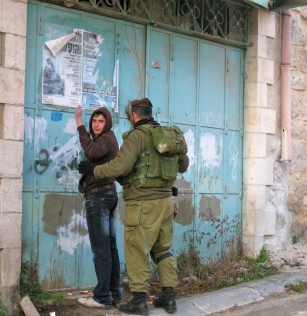 An Israeli soldier searches a 15 year old boy in Hebron.  One of the many incidents that takes place in Hebron that many Israelis don't know about. Photo EAPPI, August 2012.