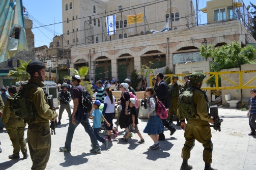 Photo EAPPI/ M. Guntern Settlers entering into the old city.  06.04.2015