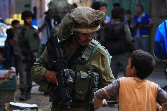 05.09.15. Hebron, Old City. Palestinian boy is stopped by soldier during Settlers Tour. Photo EAPPI /R. Leme
