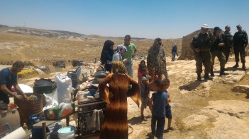 19.06.16 Residents next to belongings retrieved from homes prior to demolitions. Photo. N. Nawaja