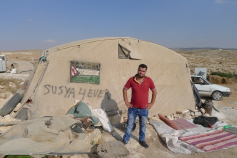Susiya augist 2016 Nasser spokesman of Susiya in front of a tent in susiya1 photo EAPPISHH